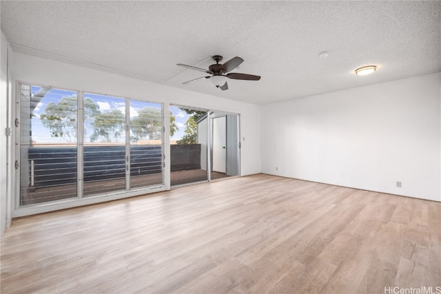 spare room featuring a textured ceiling, light hardwood / wood-style floors, and ceiling fan