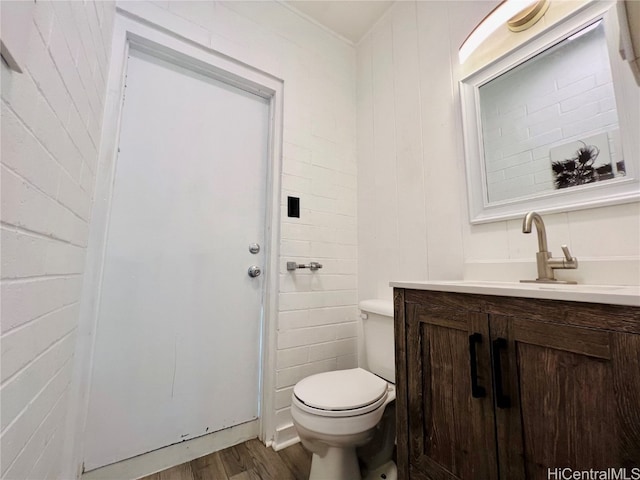 bathroom with vanity, toilet, and wood-type flooring