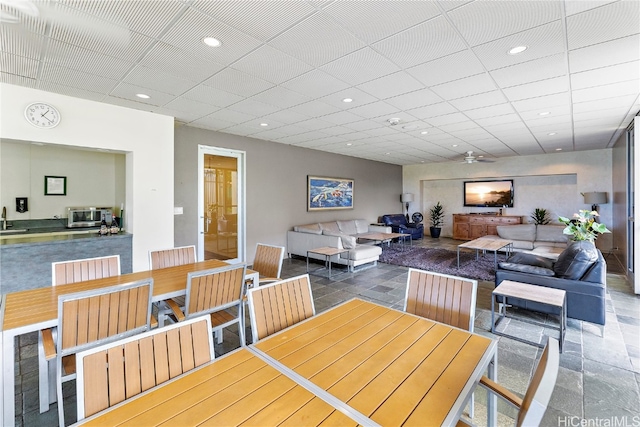 tiled dining room with sink and ceiling fan