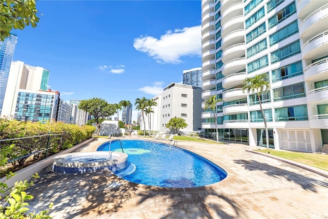 view of pool with a hot tub