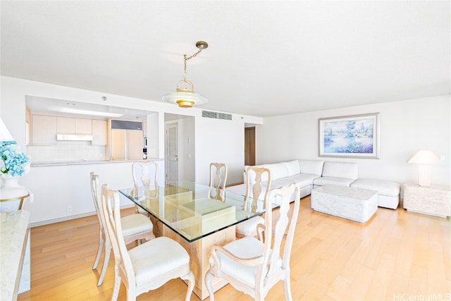 dining space featuring light wood-type flooring