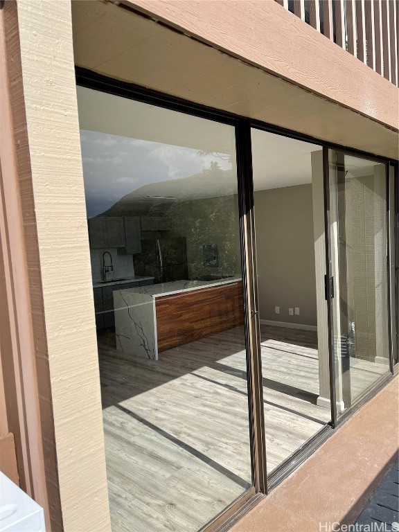 exterior space with wood-type flooring and sink