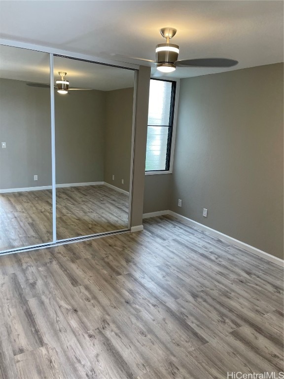 unfurnished bedroom with a closet and hardwood / wood-style flooring