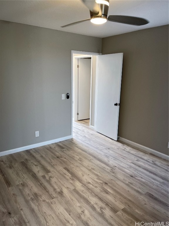 spare room with light hardwood / wood-style floors and ceiling fan