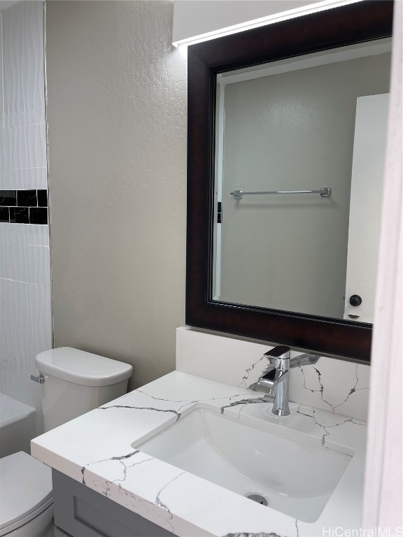 bathroom featuring vanity and toilet