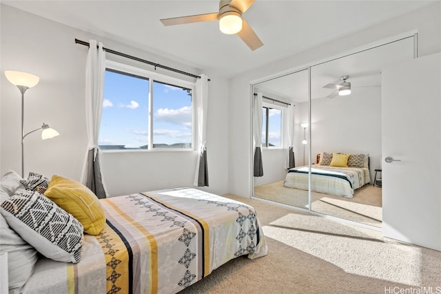 carpeted bedroom with a closet and ceiling fan