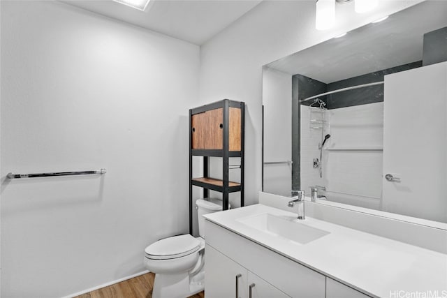 bathroom with vanity, hardwood / wood-style floors, and toilet