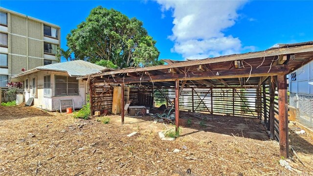 rear view of property featuring an outdoor structure