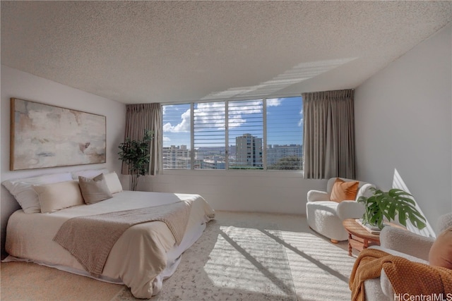 carpeted bedroom featuring a textured ceiling