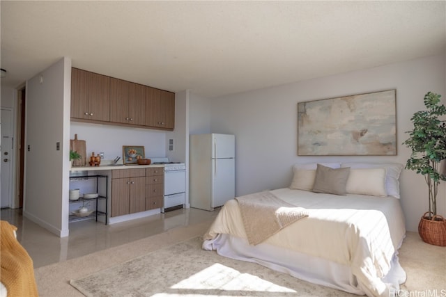 bedroom with white refrigerator and sink