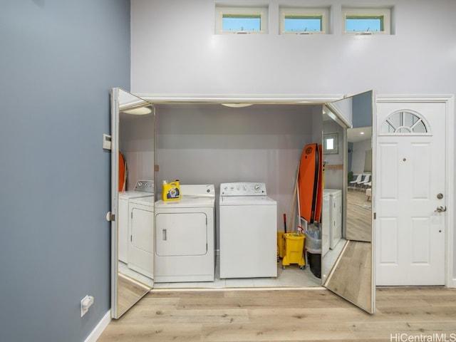 washroom with light hardwood / wood-style floors and independent washer and dryer