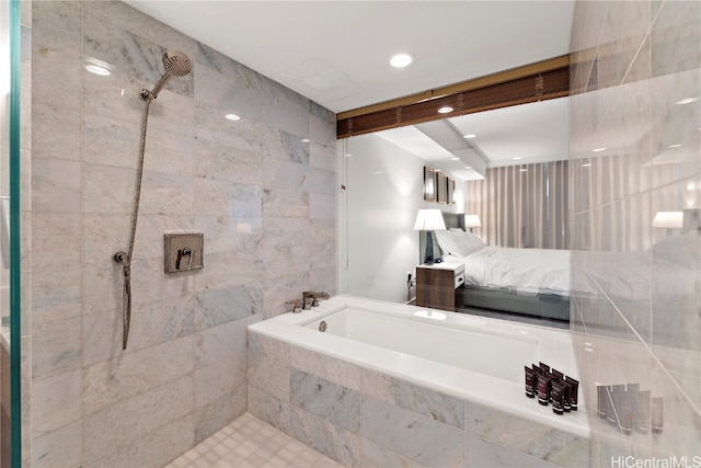 bathroom with shower with separate bathtub and tile walls