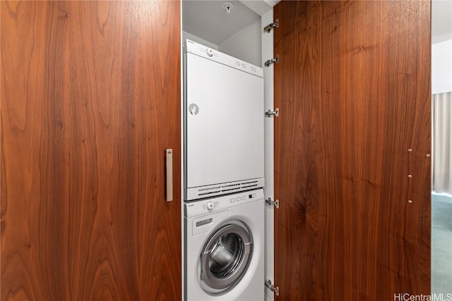 laundry area with stacked washer / dryer