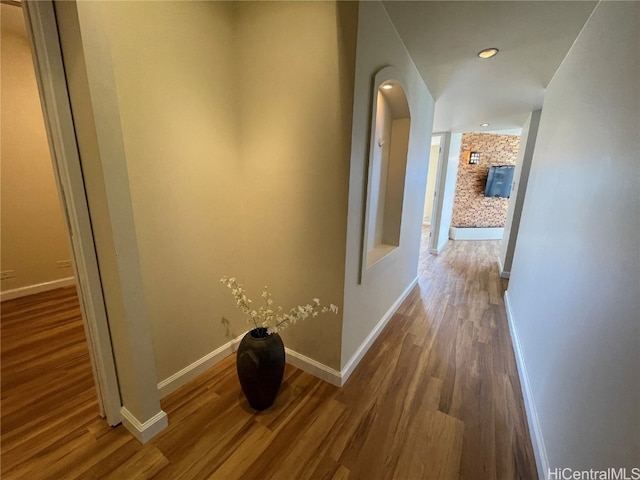 corridor with hardwood / wood-style flooring