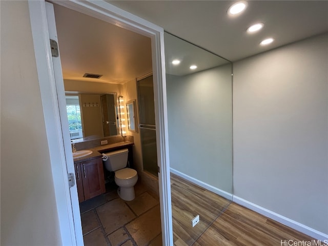 bathroom with vanity, hardwood / wood-style floors, and toilet