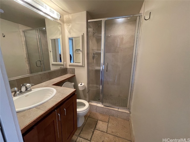 bathroom with toilet, an enclosed shower, and vanity