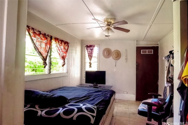 tiled bedroom with ceiling fan