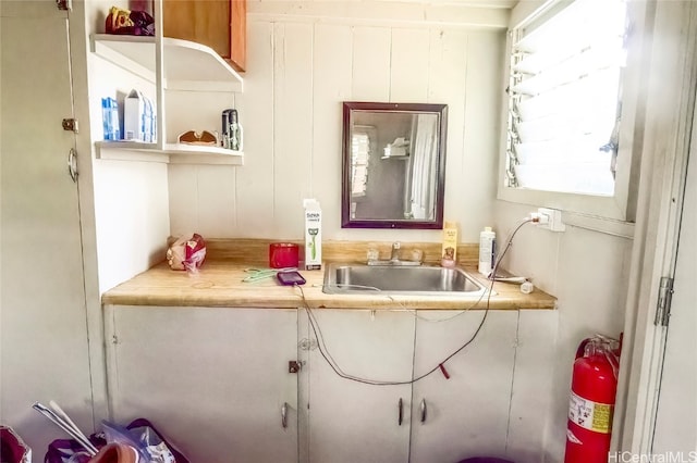 bathroom featuring vanity and wood walls