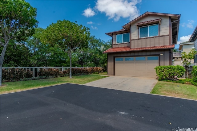 view of front of home with a front lawn and a garage