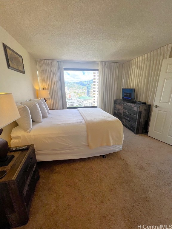 carpeted bedroom featuring a textured ceiling