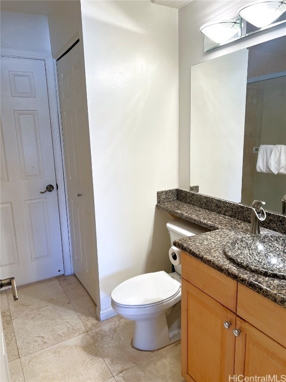 bathroom featuring vanity, toilet, and tile patterned floors