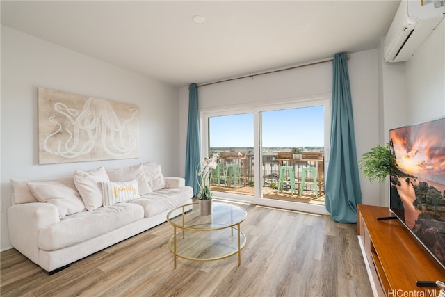 living room featuring a wall mounted air conditioner and hardwood / wood-style flooring