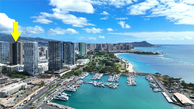 drone / aerial view featuring a water and mountain view