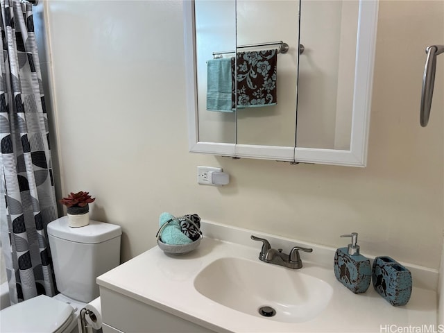 full bathroom featuring shower / bath combination with curtain, vanity, and toilet