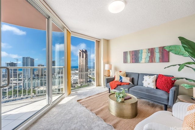 living room with a textured ceiling, carpet floors, expansive windows, and a healthy amount of sunlight