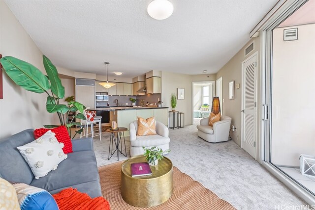 living room with light carpet and a textured ceiling