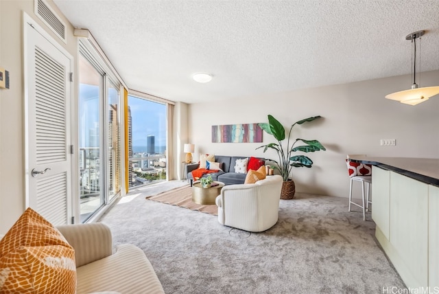 living room featuring floor to ceiling windows, light colored carpet, and a textured ceiling