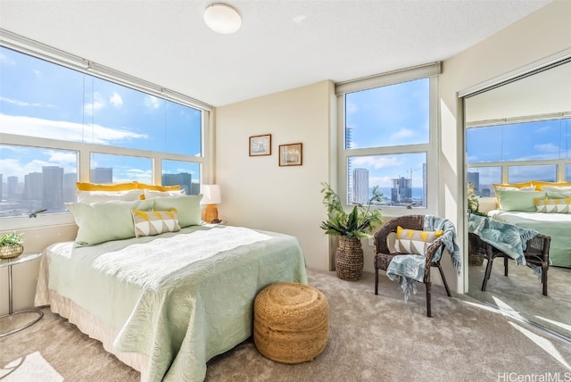 bedroom with light carpet and multiple windows