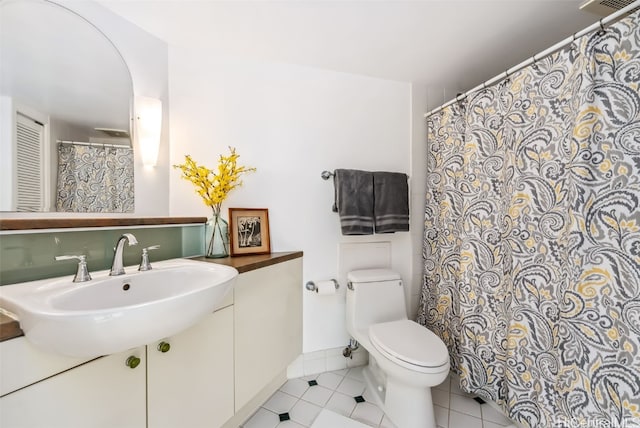 bathroom with tile patterned floors, sink, and toilet