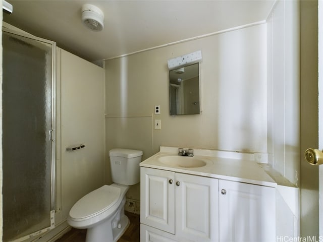 bathroom featuring vanity, an enclosed shower, and toilet