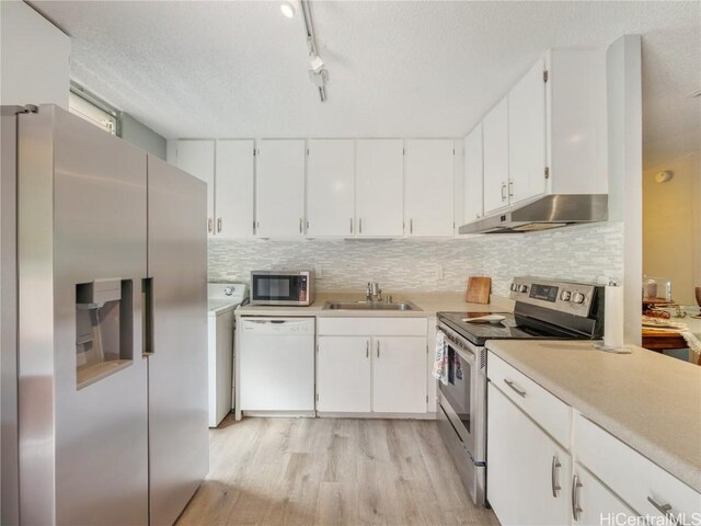 kitchen featuring backsplash, sink, white cabinetry, and stainless steel appliances