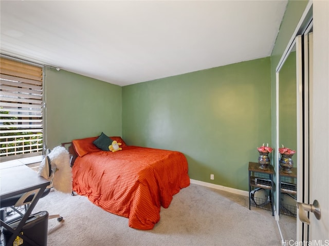 bedroom featuring a closet, baseboards, and carpet