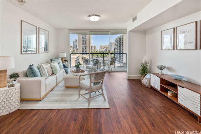 living room featuring expansive windows, hardwood / wood-style flooring, and plenty of natural light