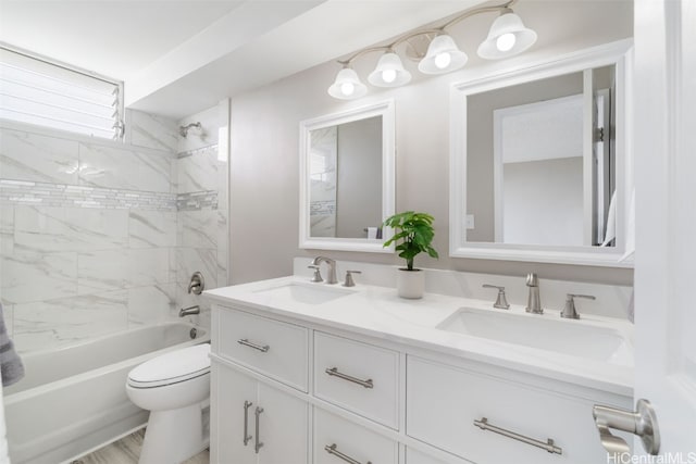 full bathroom with hardwood / wood-style floors, tiled shower / bath, toilet, and vanity