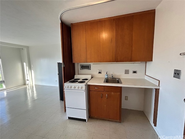 kitchen featuring sink and white range