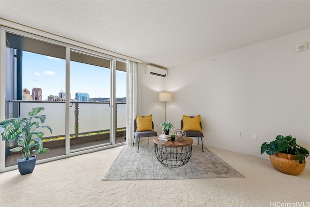 living area with carpet flooring, a textured ceiling, a wall of windows, a wall unit AC, and a water view