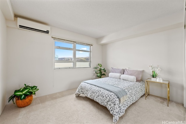 bedroom featuring carpet, a wall mounted AC, and a textured ceiling