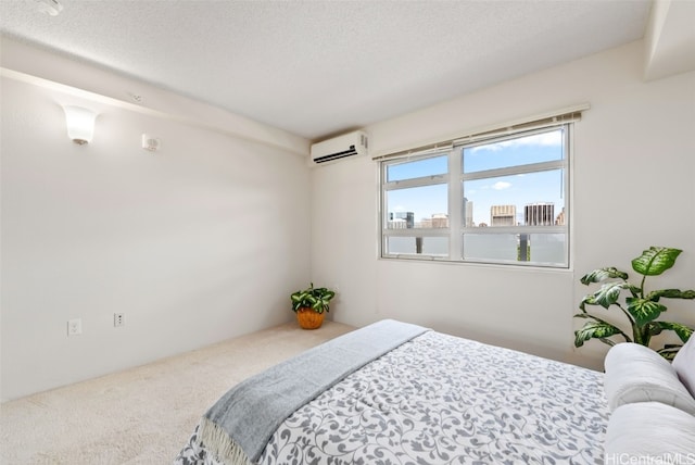 bedroom with a textured ceiling, an AC wall unit, and carpet