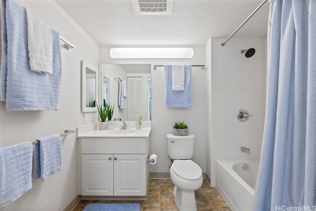 full bathroom featuring vanity, toilet, a textured ceiling, and shower / bath combo