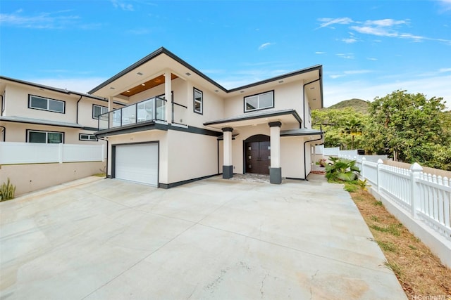 418 Halemaumau St, Honolulu, HI 96821 - contemporary house featuring a balcony, stucco siding, a garage, and driveway