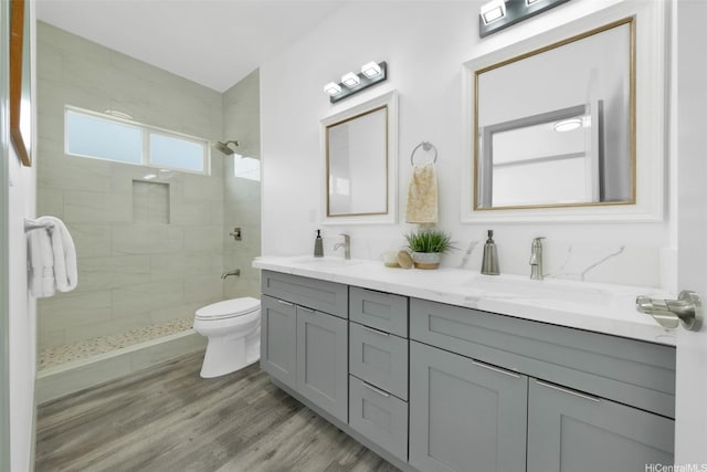 418 Halemaumau St, Honolulu, HI 96821 - bathroom featuring double vanity, toilet, a tile shower, and wood finished floors
