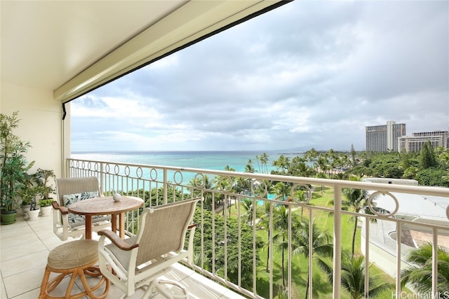 balcony featuring a water view and a beach view