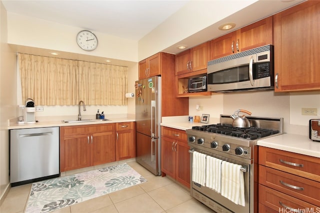 kitchen with sink, stainless steel appliances, and light tile patterned floors