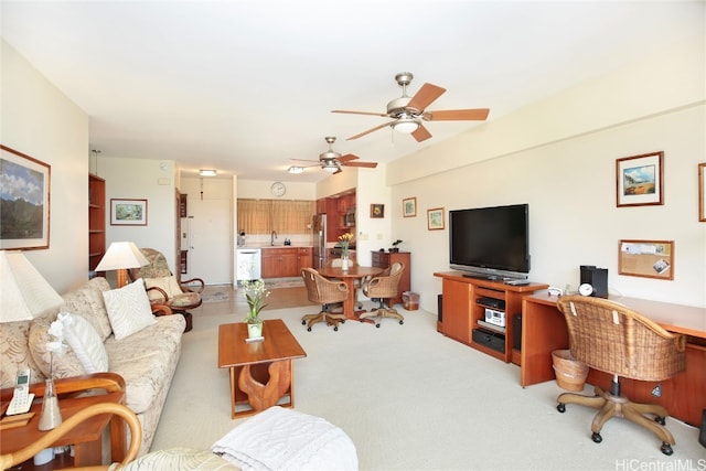 living room featuring sink, light carpet, and ceiling fan