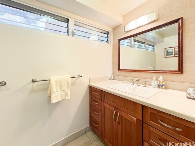 bathroom featuring vanity, a healthy amount of sunlight, and tile patterned floors