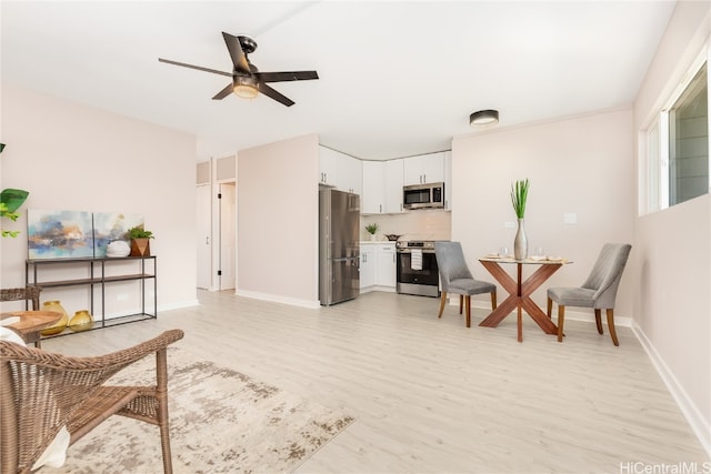 sitting room featuring light wood-type flooring and ceiling fan